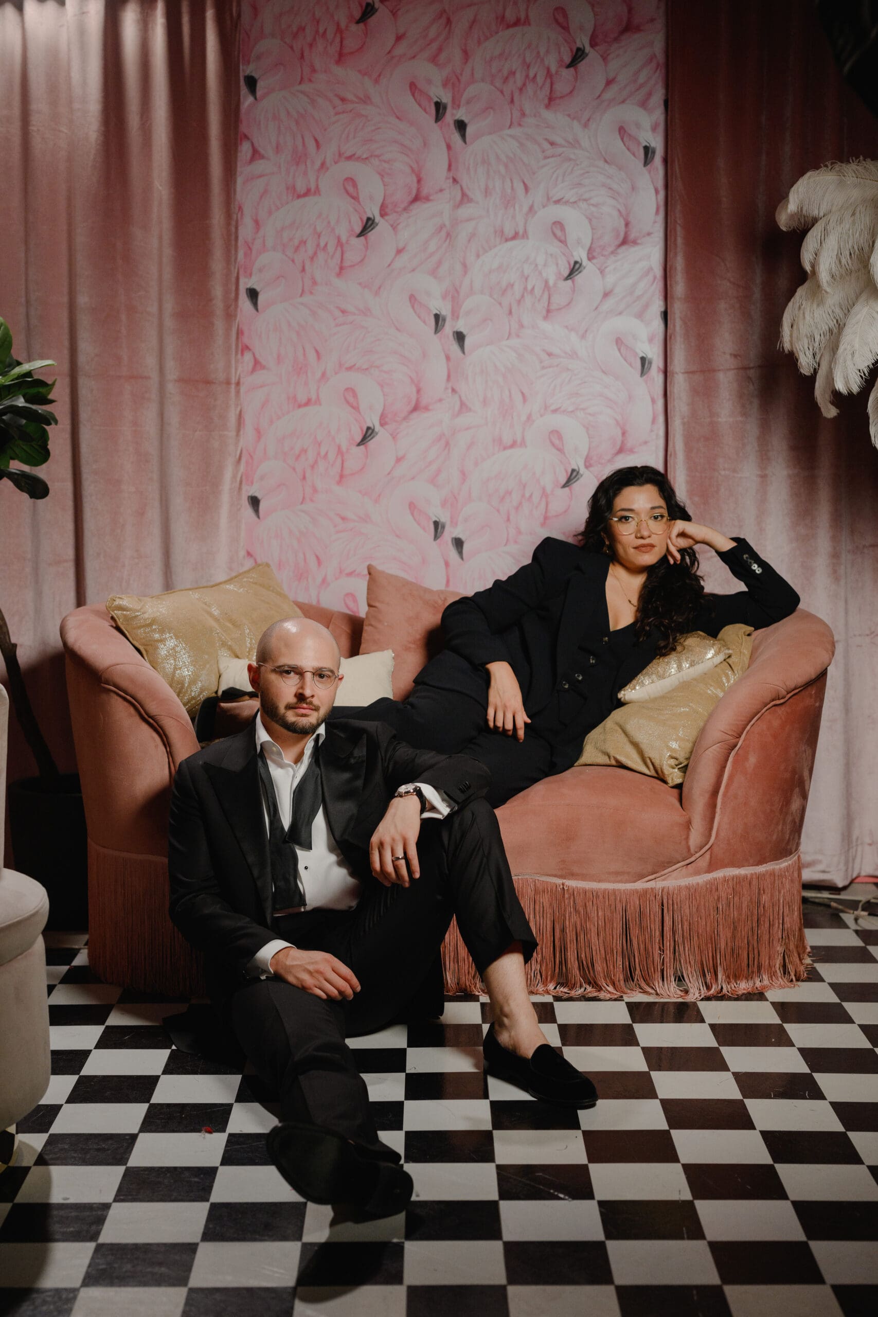 Alex and Carolina, founders of Straight to the Heart wedding photography, seated together in a styled portrait.